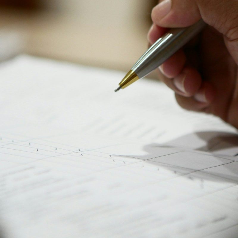 a hand holding a pen